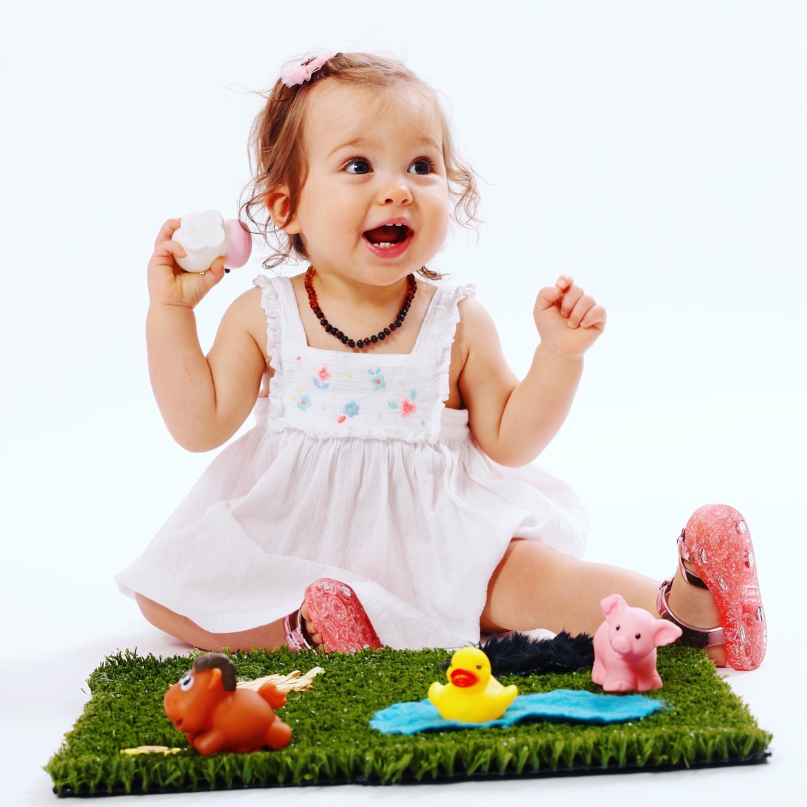 happy toddler girl with sensory toys